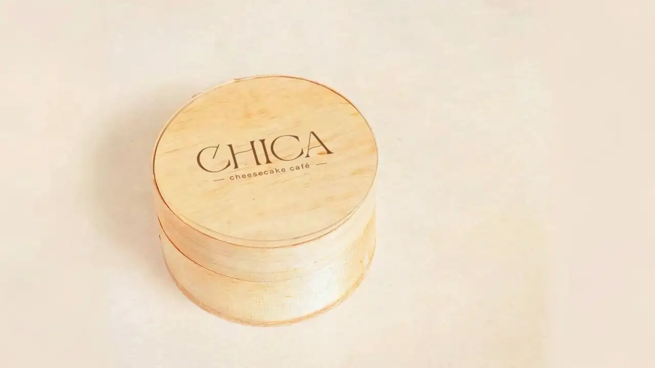 La caixa de fusta de CHICA, tancada, amb el logotip gravat a la tapa